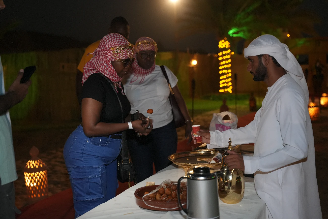 Arabic coffee being served to a guest at camp