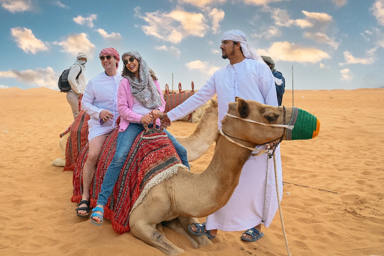 Family enjoying a camel ride in the Dubai desert