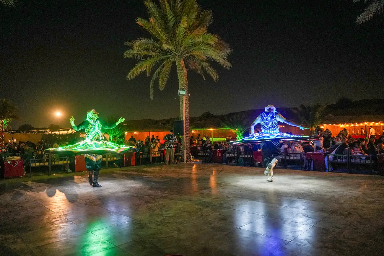 Desert safari camp illuminated for evening entertainment